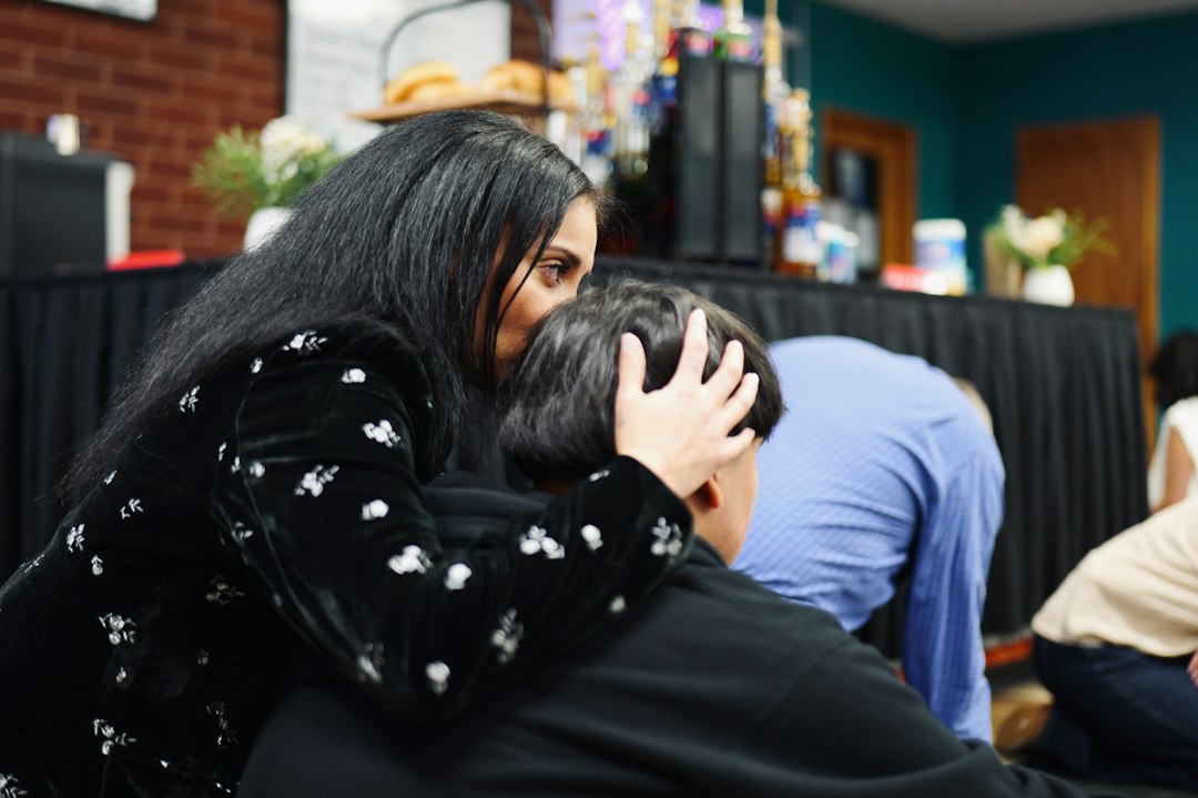 A woman comforting someone during a church gathering