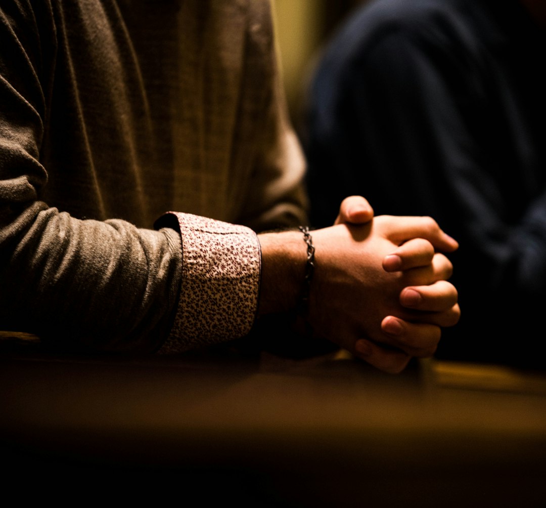 Two people holding hands across a table