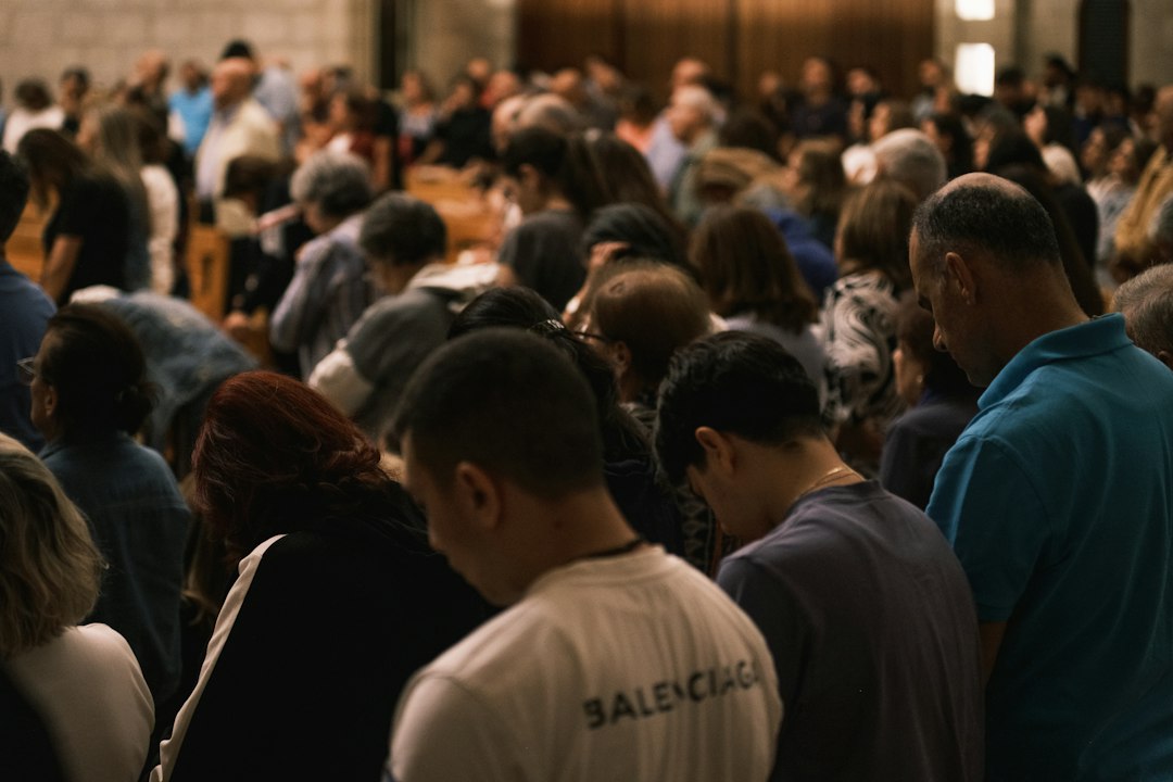 A congregation bowing their heads in prayer